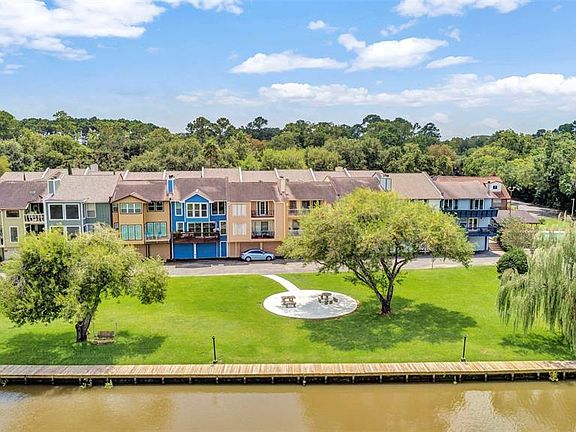 On the Dickinson Bayou, note the bulk head across the back of the property, fishing and picnicking right out your back door. Your new home is the darker blue townhome.