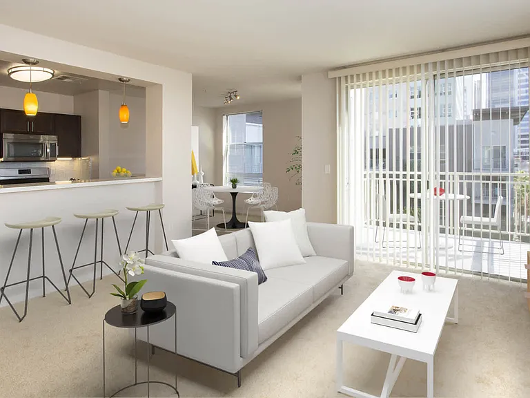 Carpeted Living Room with Balcony