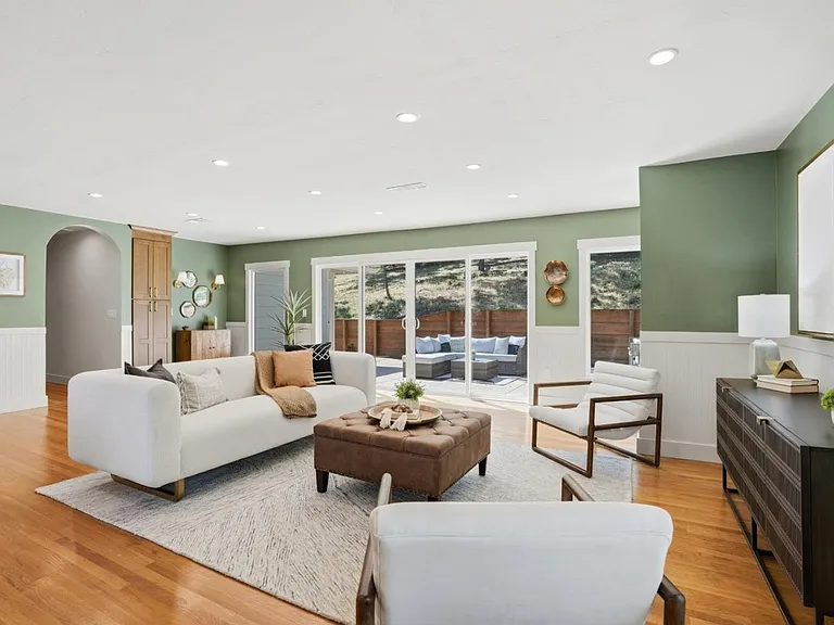 Large windows framing peaceful tree-lined surroundings