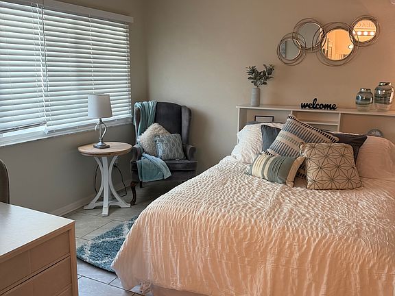 left sitting area side of room facing picture window/desk