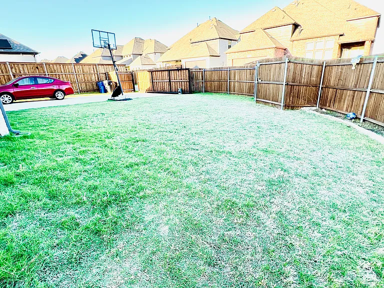 Private backyard with an extended fence and secure gate