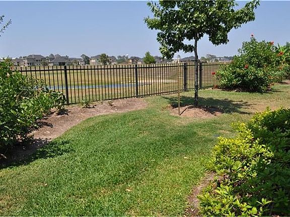 Sprinkler system, custom drainage system, fully landscaped with access gate to pond area