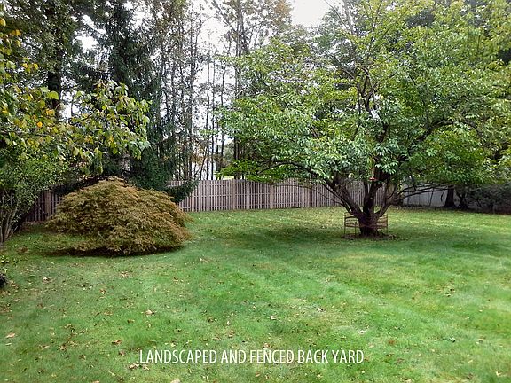 The backyard is large, fenced and nicely landscaped with many specimem trees. Great for lounging, cookouts or just playing.