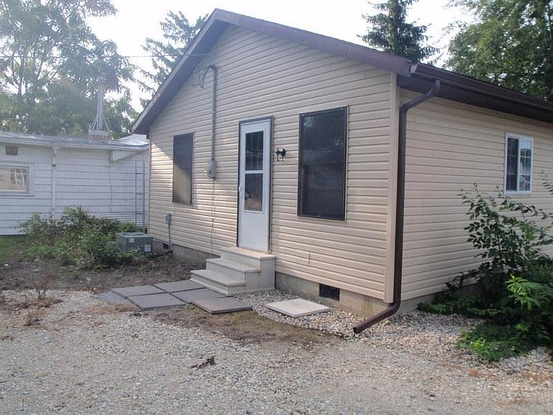 Side door. Gravel parking.