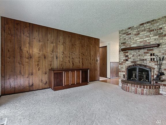 Dining area with fireplace and entrance to hallway