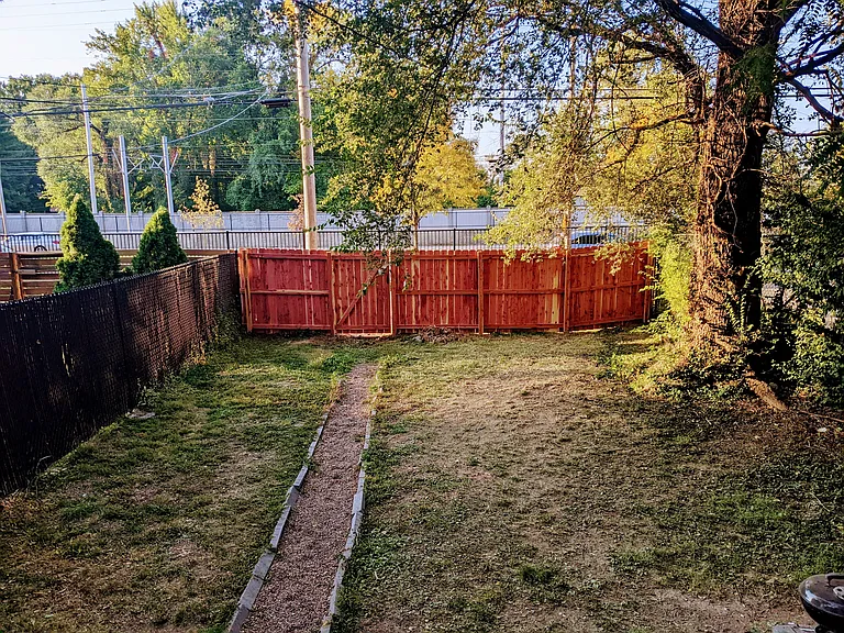Private backyard with brand-new wooden fence.