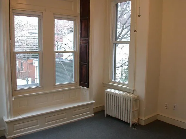 back bedroom, seating under the window, different view.