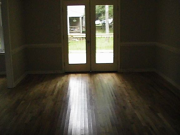 Hardwood floors in great room with french doors leading to large deck