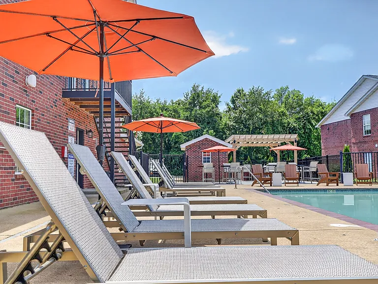 Newly furnished sundeck with umbrellas for shade at Saddlebrook Apartments.