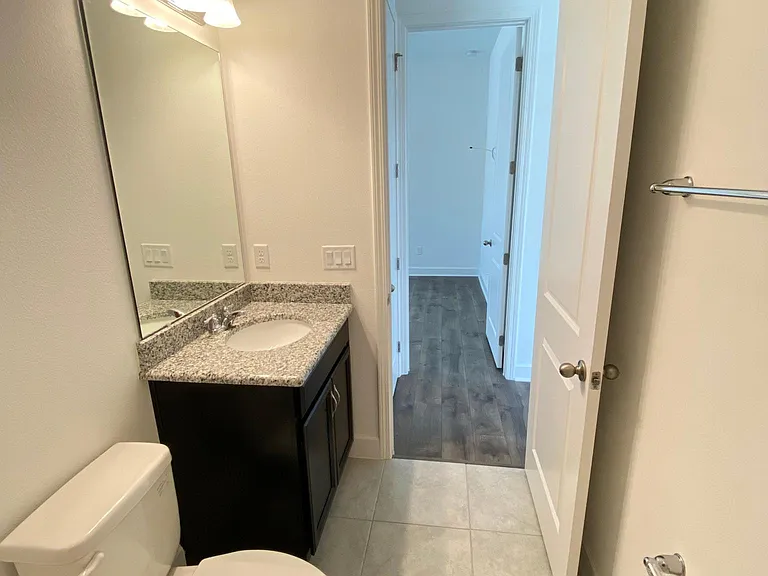 From inside the bathroom looking out to the main bedroom.