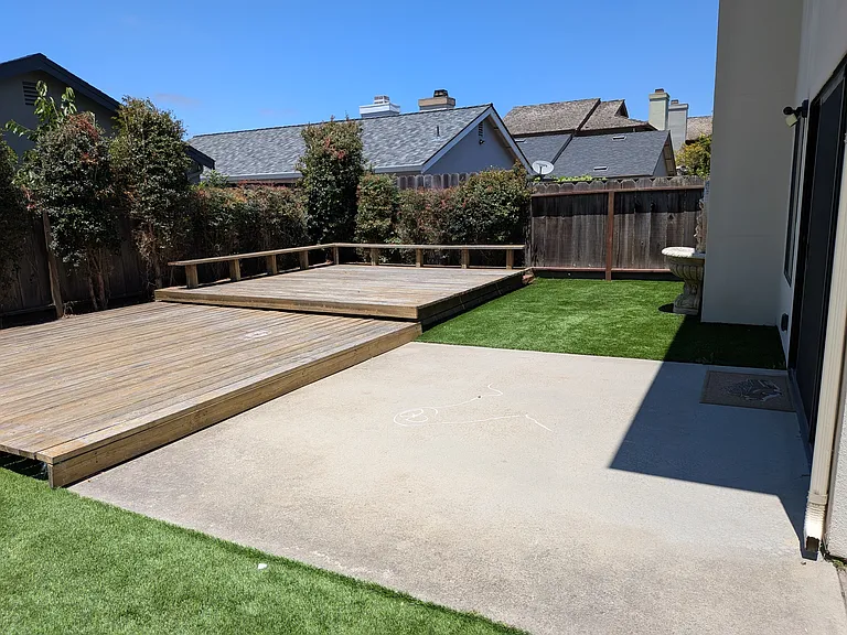 Backyard patio and wood deck with benches