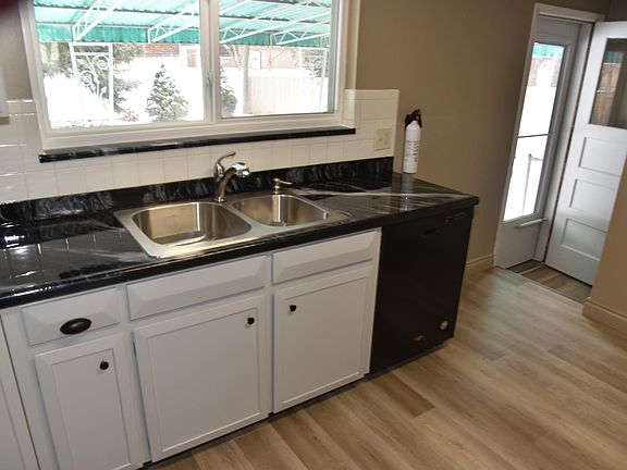 Kitchen with 2-year-old dishwasher. The back door to a spacious, fenced backyard.
