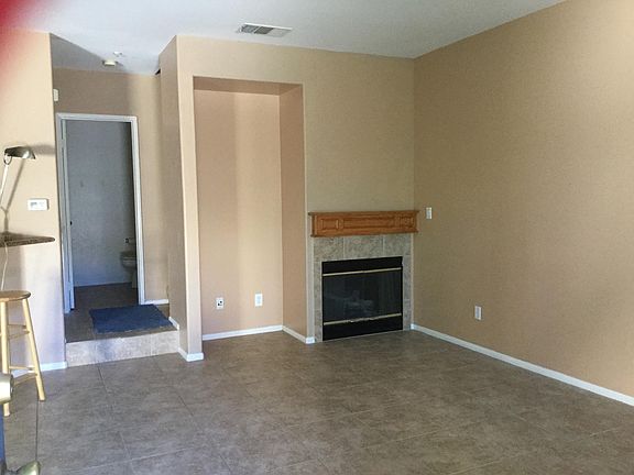 Living room fireplace. Entrance to half bath.
