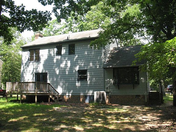 Rear yard features natural landscape