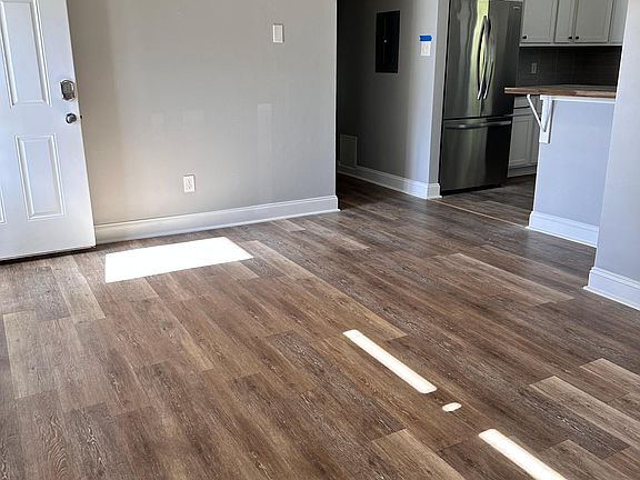 Living room, looking at kitchen and hall.
