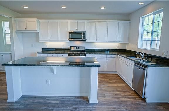 Granite kitchen counters and white cabinets