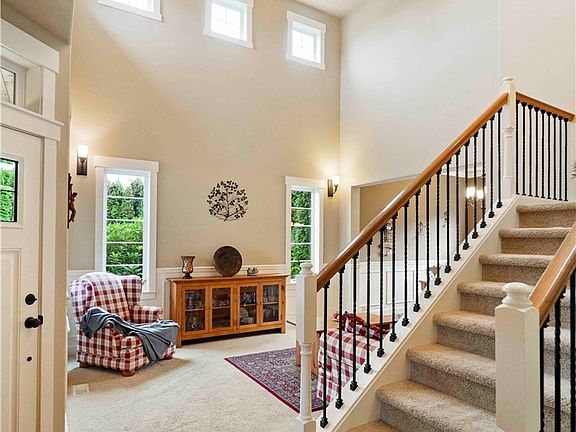 Hardwood floors on main.  Open Iron staircase railing.  