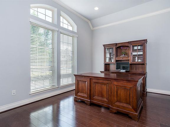 French doors lead into the study with gorgeous hardwood floors, tall ceilings and crown molding.