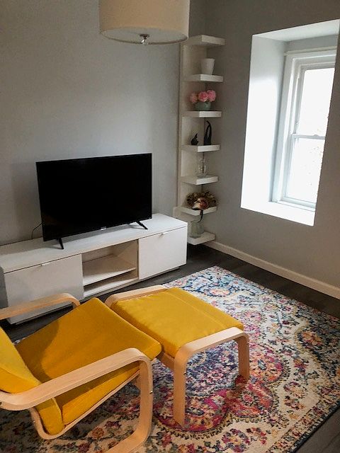 Chair and TV in front of Sofa