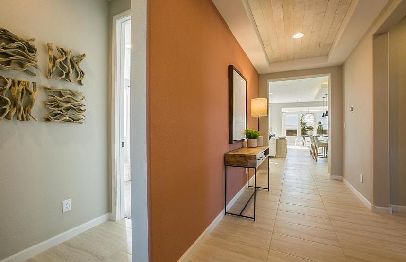 Through the front door you ll find the secondary bedrooms to the left and open living areas straight