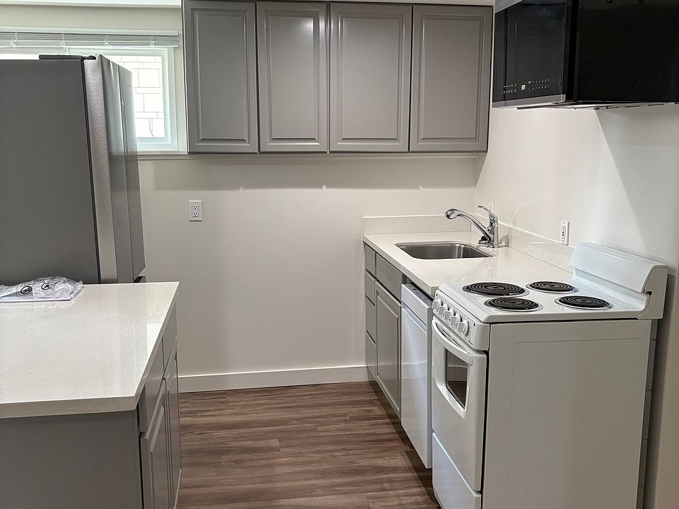 Kitchen with new refrigerator. Microwave and dishwasher