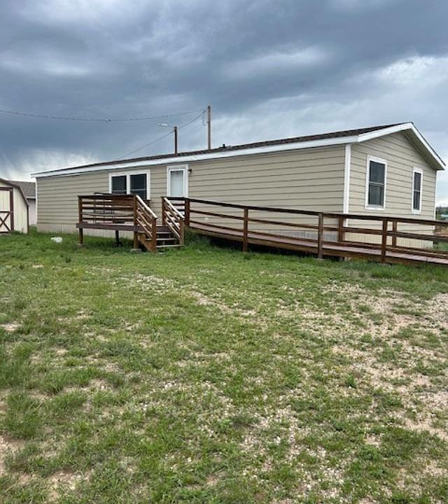 front entrance with porch and handicap ramp.