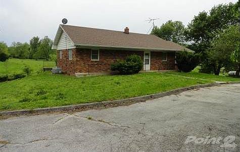 Brick home on Hwy 32 with 23 acres and barn.