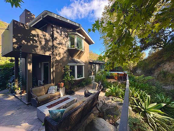 On the left is the dining patio, center is a fire pit and seating area, on the right is the creek.