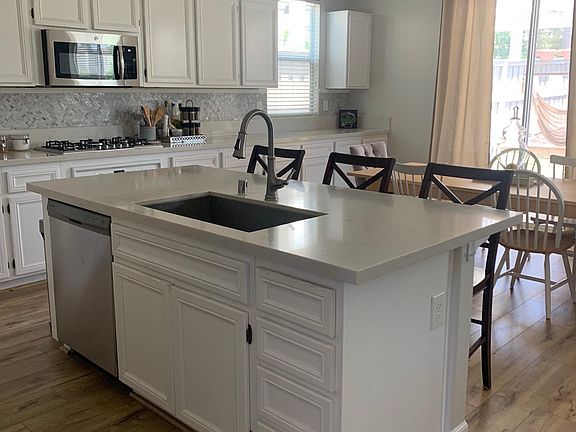 Kitchen with center island, quartz counters, stainless steel appliances