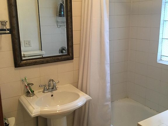 Fresh, white bathroom with original tile.