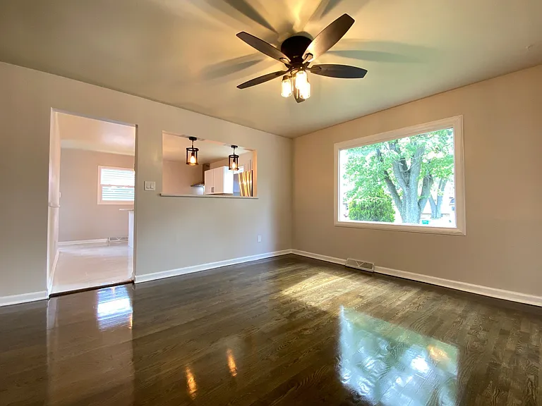 Living room shows a large window.