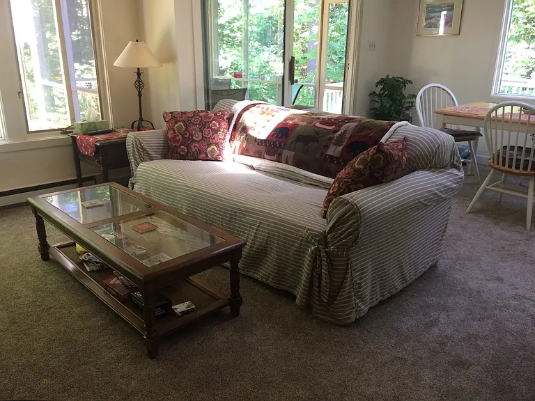 Living room, dining room and slider to screened porch and sunny deck