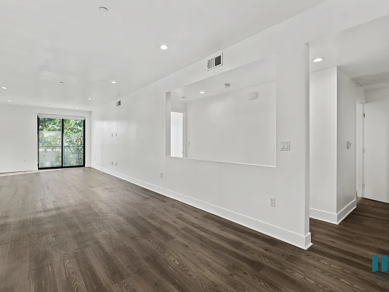 Open-Concept Dining and Living room Space with Balcony, Vinyl Flooring, and Recessed Lighting