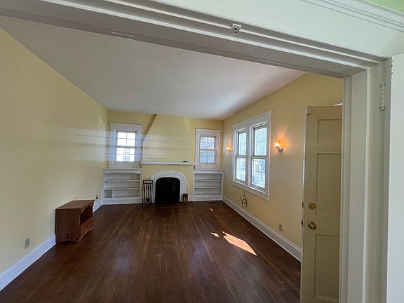 looking at the Den roomy size ,natural light, built in book cases, fireplace