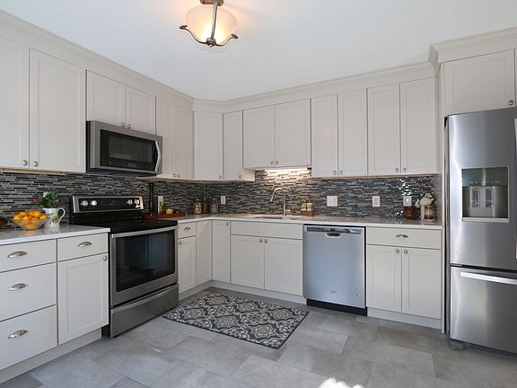 Quartz counters, stainless appliances, tile floor