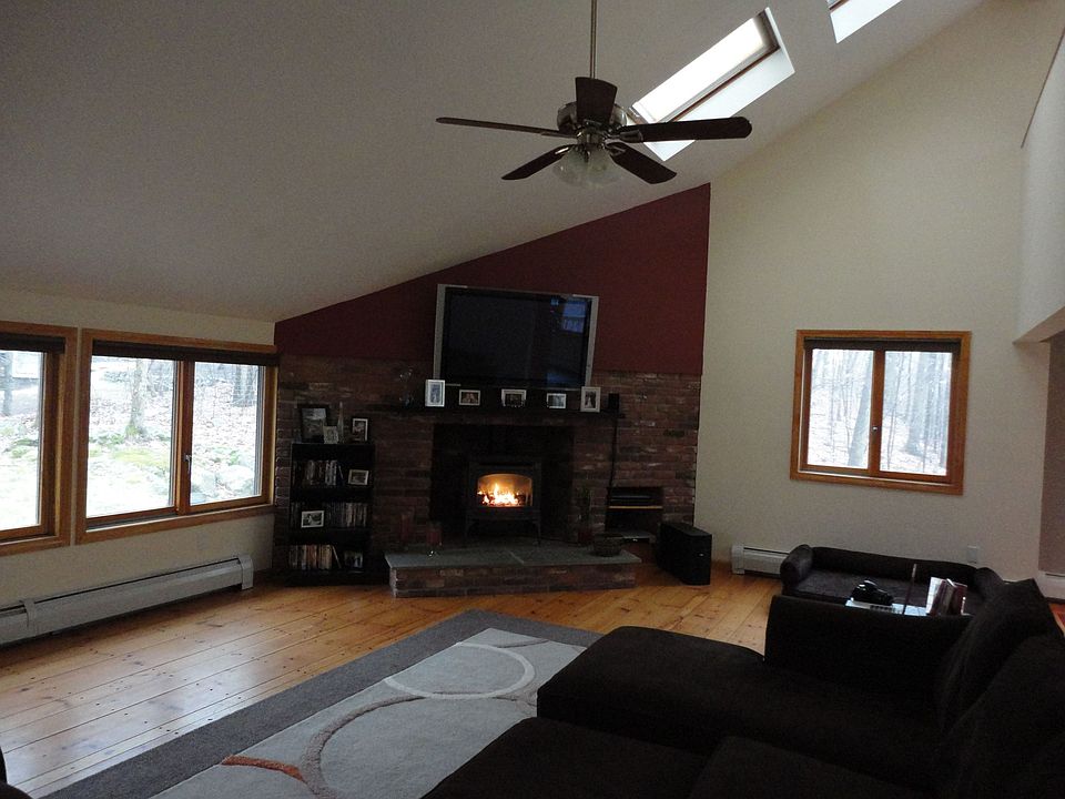 Living room with winde pine plank floor and gas fireplace stove