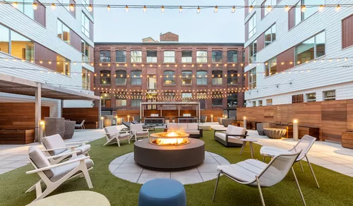 Your new home includes a large central social area with firepits, fitness center, and co-working spaces. - Prism