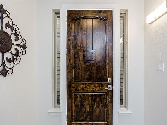 The entry is light and bright with sidelights that flank the handsome front door.
