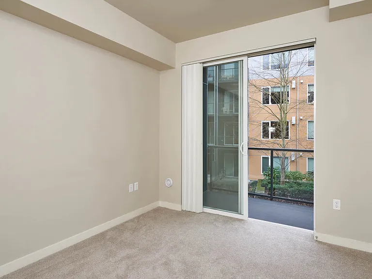 Carpeted Bedroom with Balcony