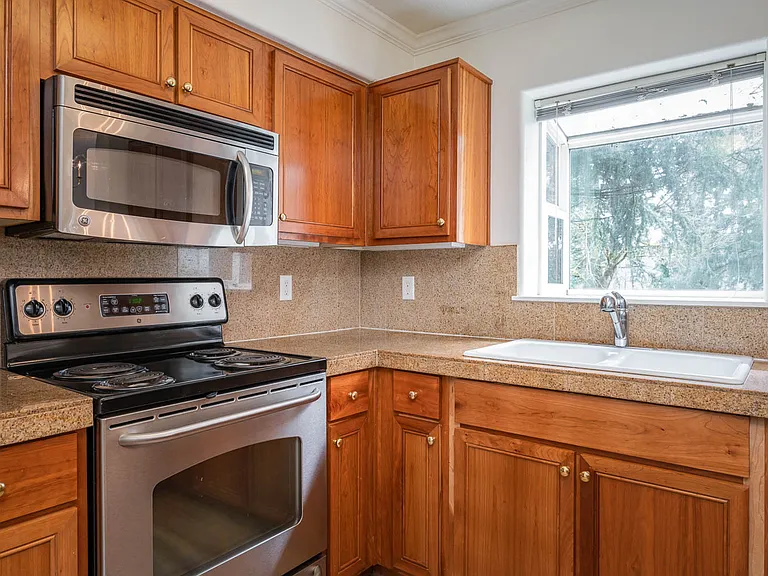 Village at Main Street | 2x2 Kitchen with Wood Cabinetry and Stainless Steel Appliances