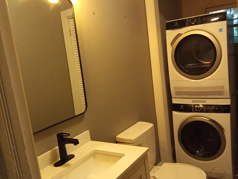 Downstairs half bath with washer dryer