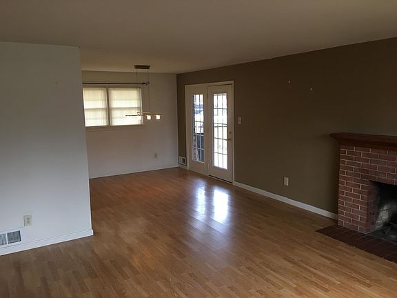 Family/Dining Room Facing Towards Back of Home. French Door Leading to Carport & Backyard.