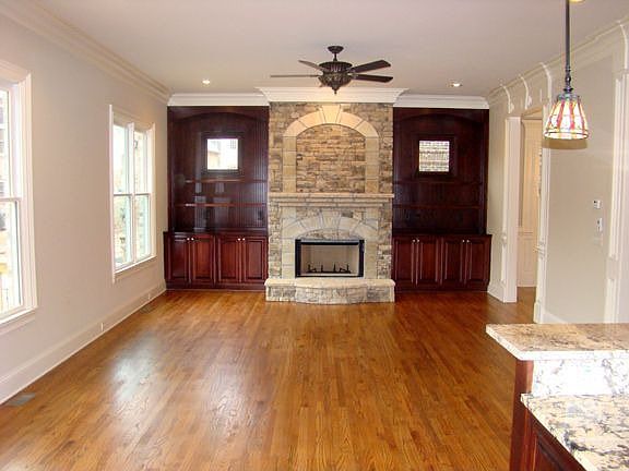 Oversized Family Room with stone fireplace, built book cases