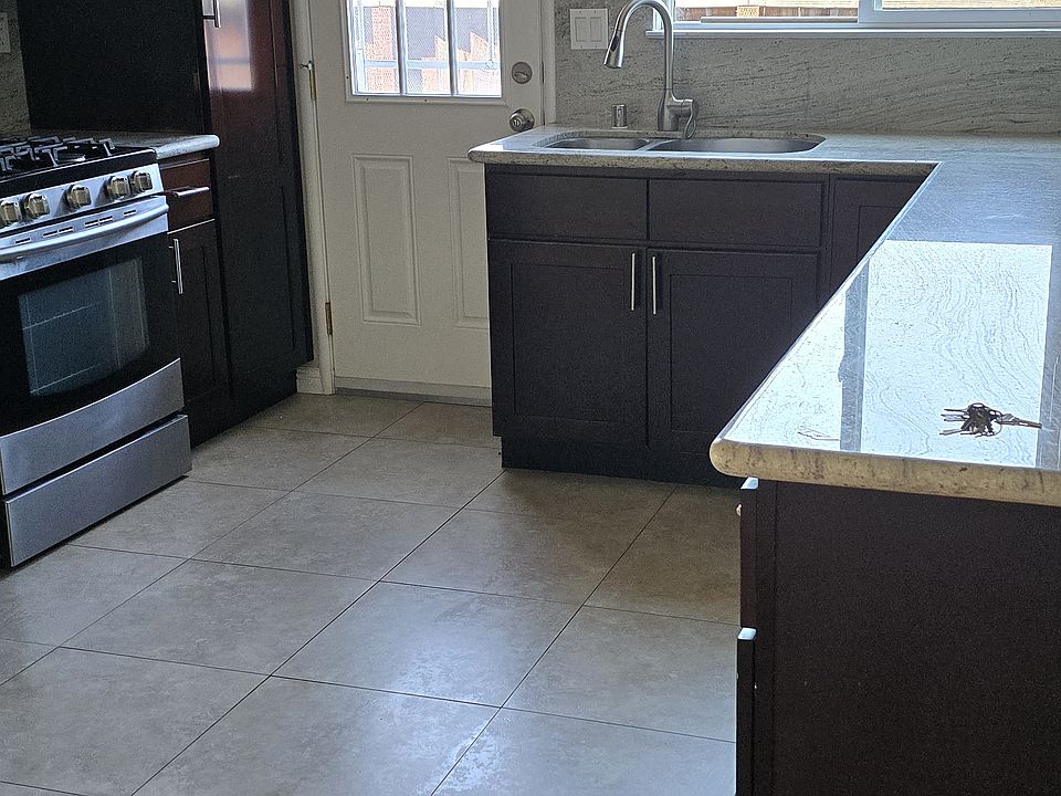 Kitchen with door to access side and back yard