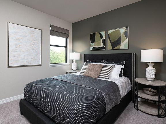 The fourth bedroom is a perfect in-law suite features plush carpet, an accent wall and access to a p