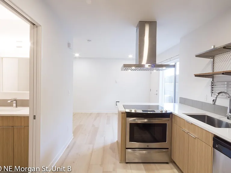 Kitchen features full size range, quartz counters, and under-mount sink.