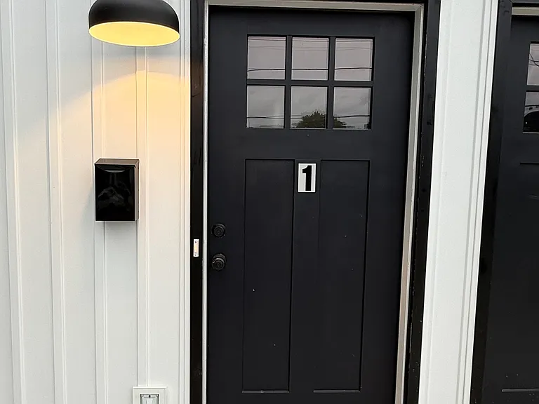Spacious private front parking with one dedicated off-street parking space for each unit, convenient front-door access, attractive front porch, and energy-efficient LED exterior lighting for added visibility and convenience.
