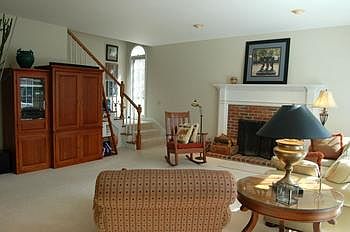 Family room with fireplace is adjacent to the kitchen area.