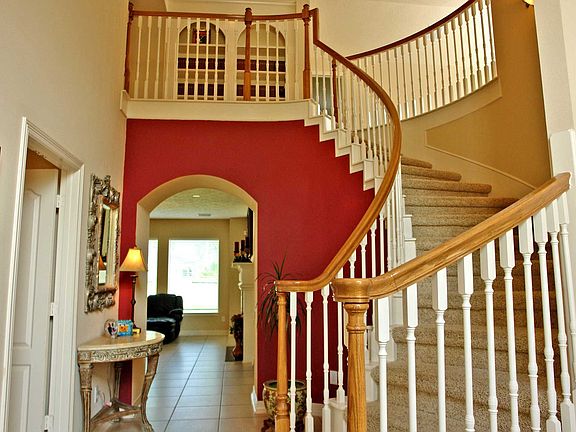 Gorgeous foyer with soaring ceilings and spiral staircase 