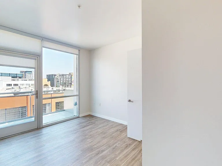 Spacious apartment Bedroom with Wood-Style Flooring.